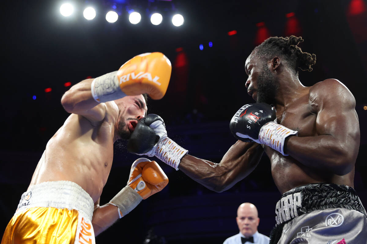 Denzel Bentley, right, connects a punch against Janibek Alimkhanuly, in the 11th round of a WBO ...