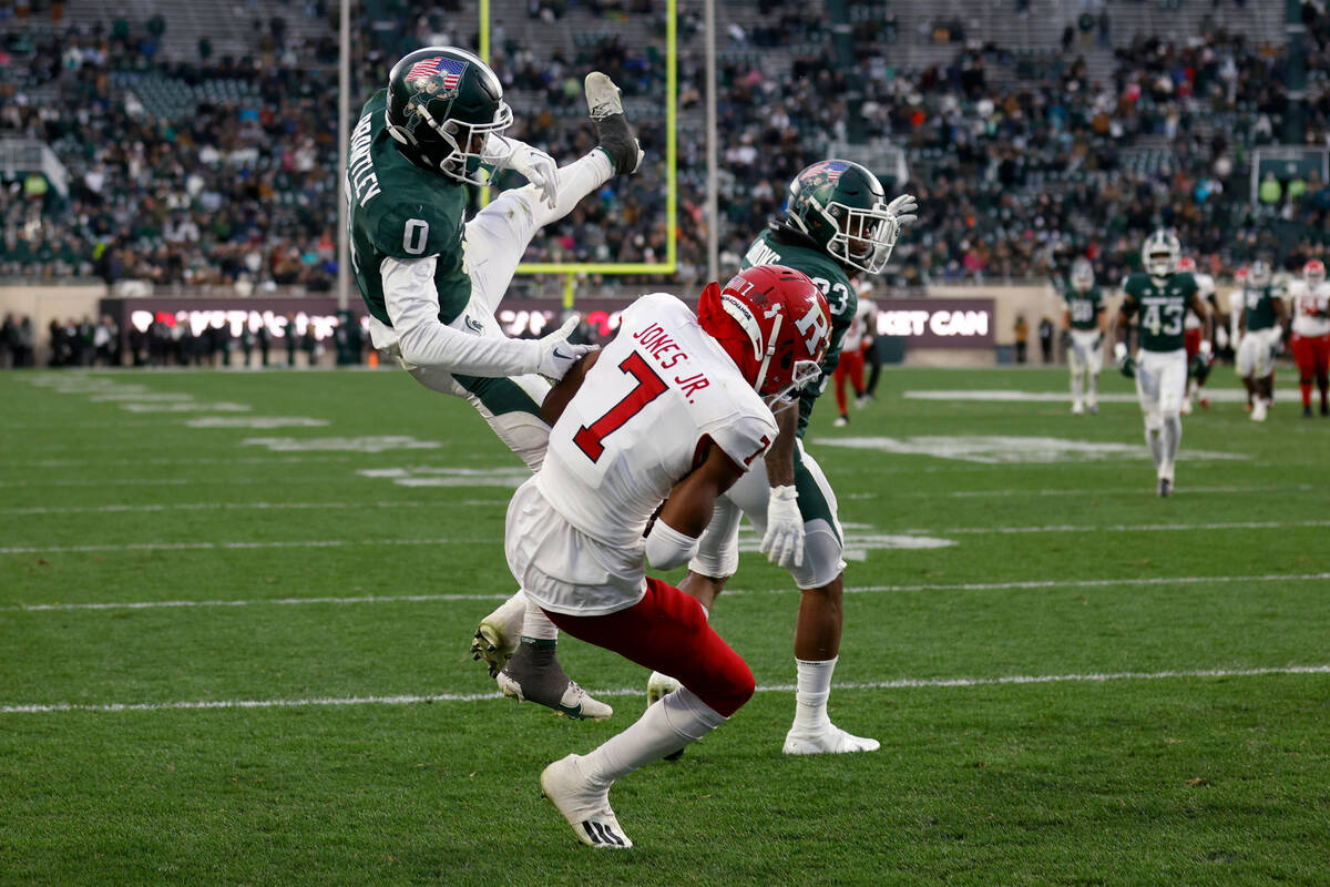 Rutgers' Shameen Jones, center, catches a pass for a touchdown against Michigan State's Charles ...
