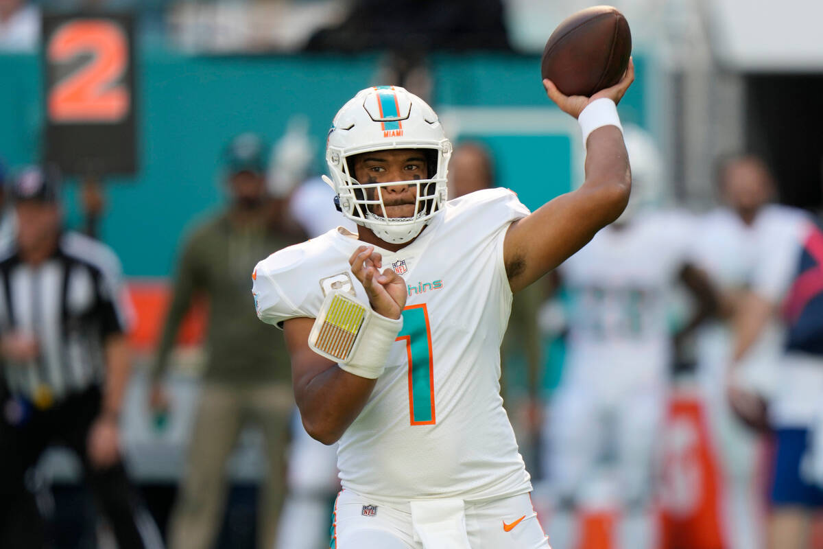 Miami Dolphins quarterback Tua Tagovailoa (1) looks to pass the ball during the first half of a ...