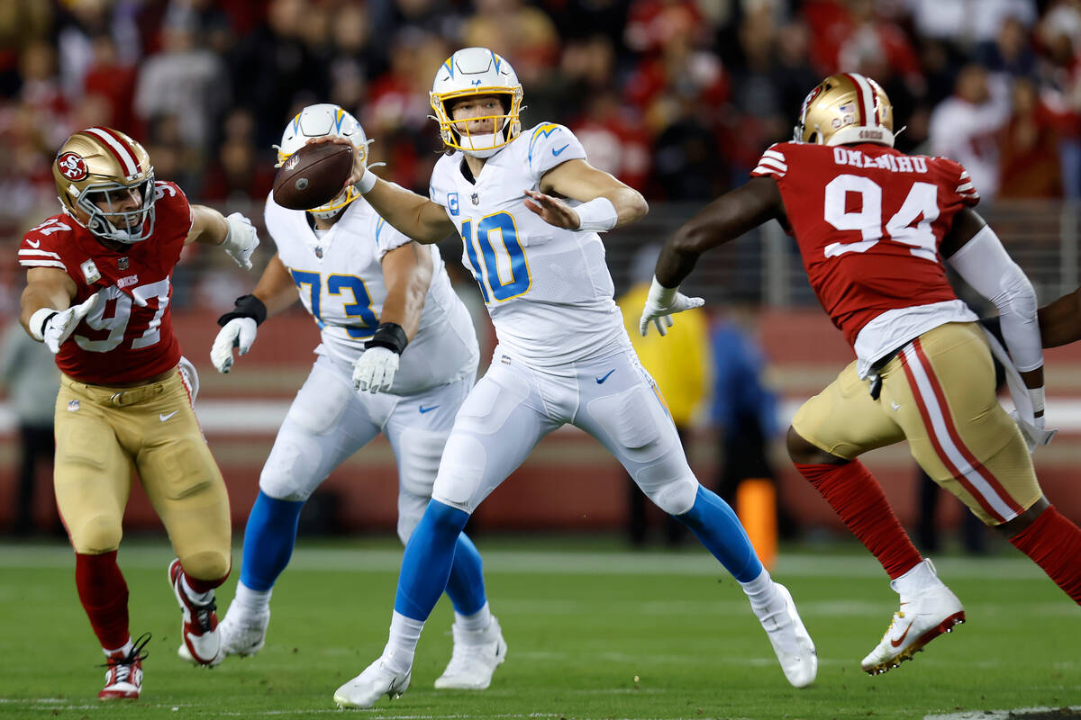 Los Angeles Chargers quarterback Justin Herbert (10) passes while pressured by San Francisco 49 ...