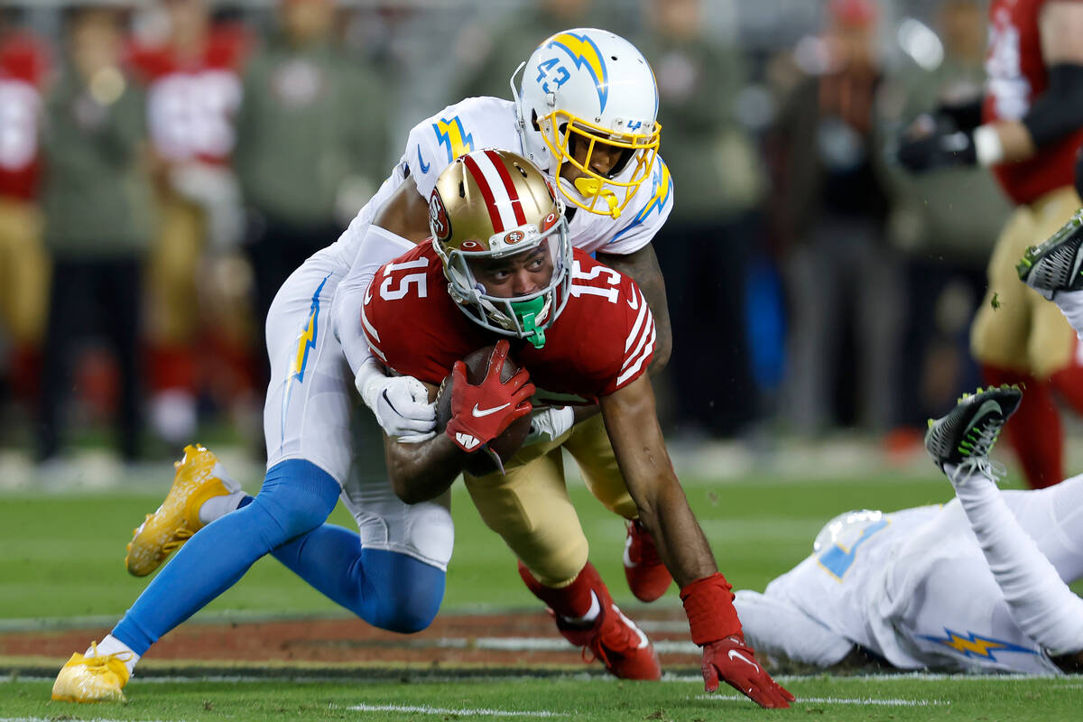 San Francisco 49ers wide receiver Jauan Jennings (15) is tackled by Los Angeles Chargers corner ...