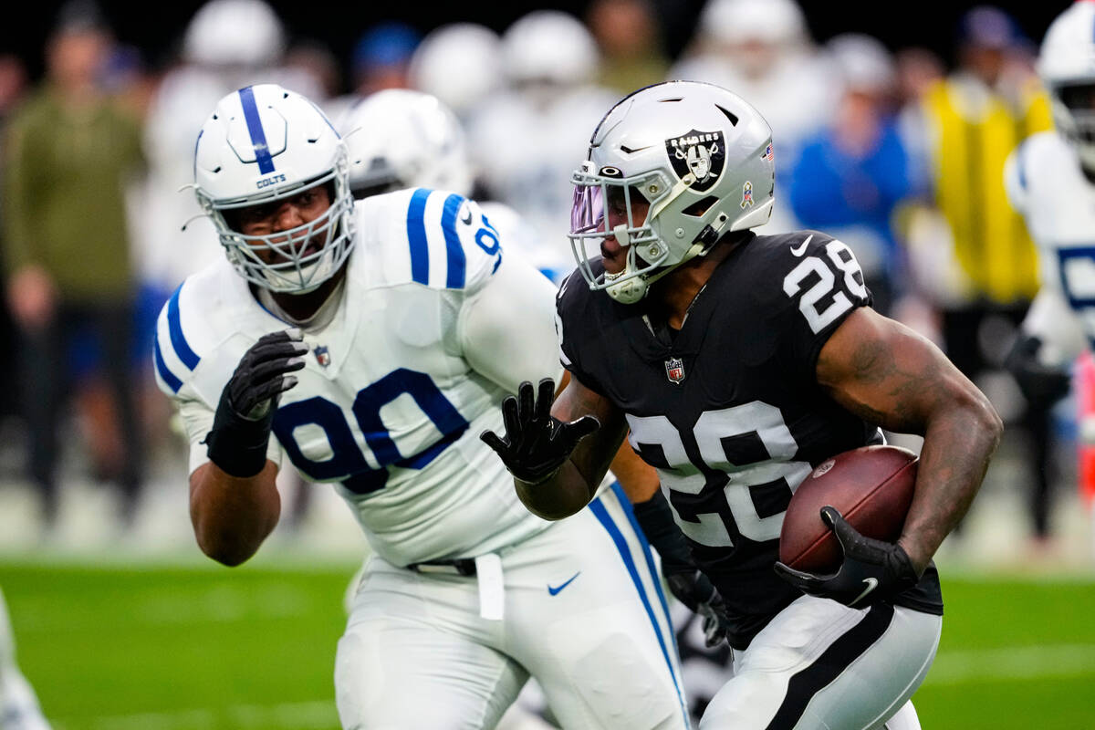 Las Vegas Raiders running back Josh Jacobs (28) tries to get past Indianapolis Colts defensive ...