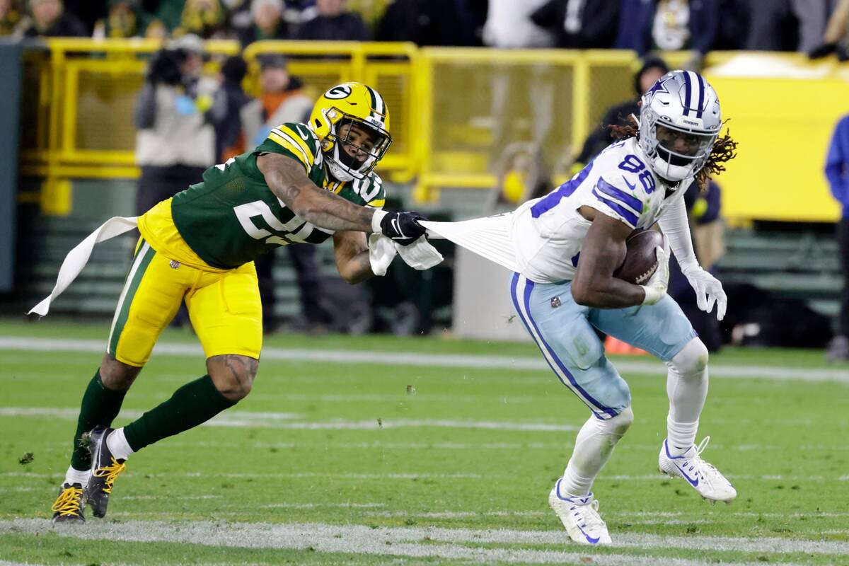 Dallas Cowboys wide receiver CeeDee Lamb (88) is stopped after catching a pass by Green Bay Pac ...