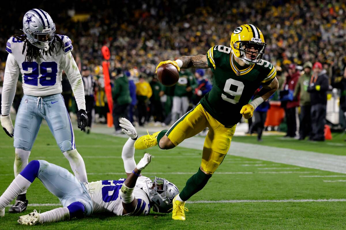 Green Bay Packers wide receiver Christian Watson (9) scores a touchdown after getting past Dall ...