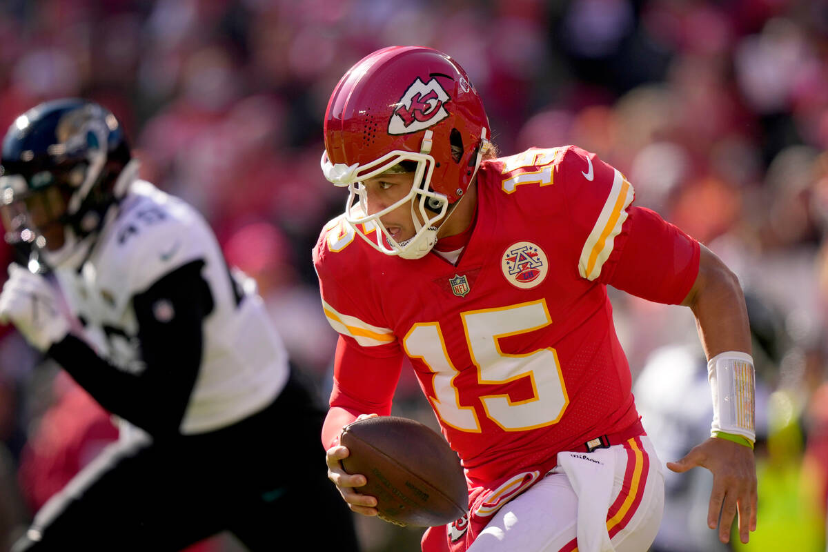 Kansas City Chiefs quarterback Patrick Mahomes scrambles during the first half of an NFL footba ...