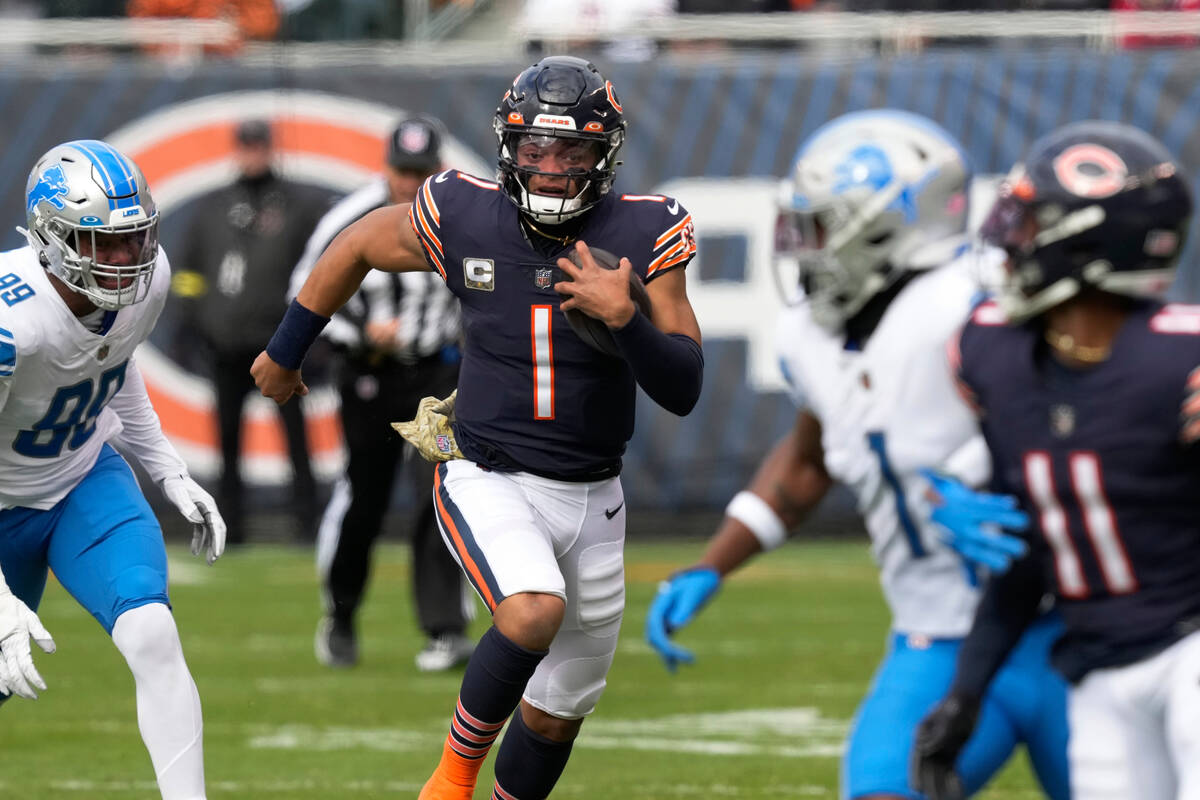 Chicago Bears quarterback Justin Fields (1) runs the ball against the Detroit Lions during the ...