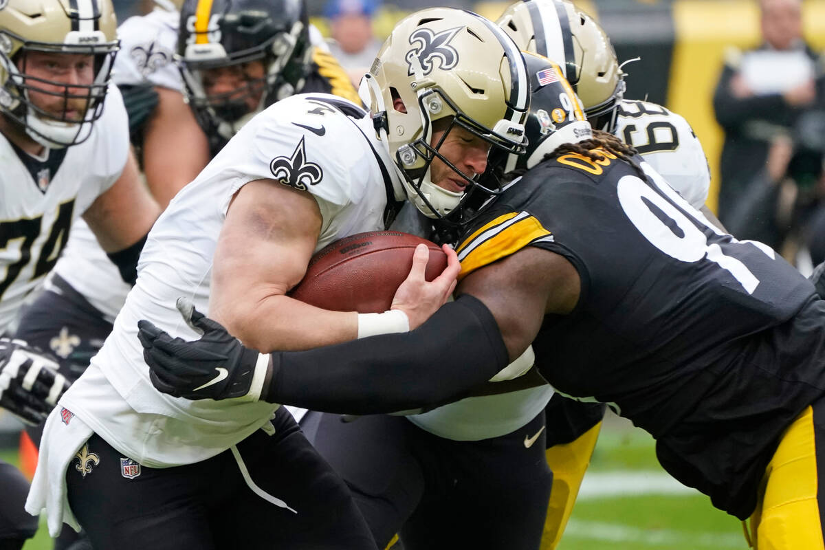 New Orleans Saints tight end Taysom Hill (7) is tackled by Pittsburgh Steelers defensive tackle ...