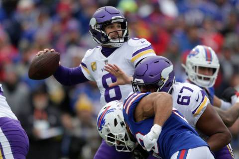 Minnesota Vikings quarterback Kirk Cousins (8) looks to pass while under pressure from Buffalo ...