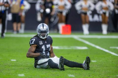Raiders wide receiver Davante Adams (17) sits dejected on the turf after a failed drive late ve ...