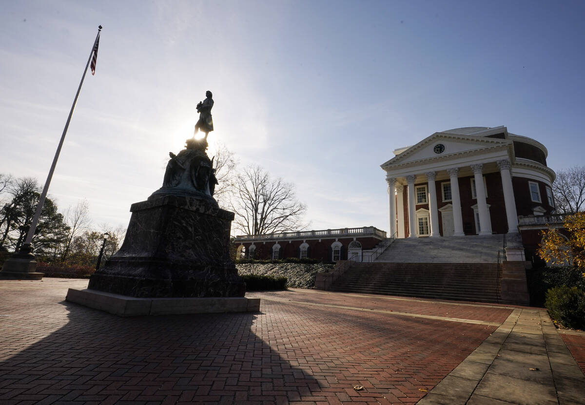 A statue of University of Virginia founder, Thomas Jefferson, stands watch over the Rotunda nea ...