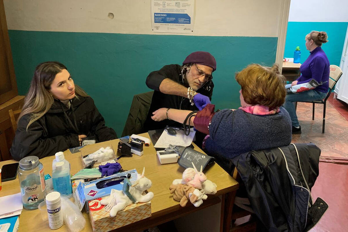 Las Vegas registered nurse Eduardo Resto, second from left, treats patients in Ukraine as part ...
