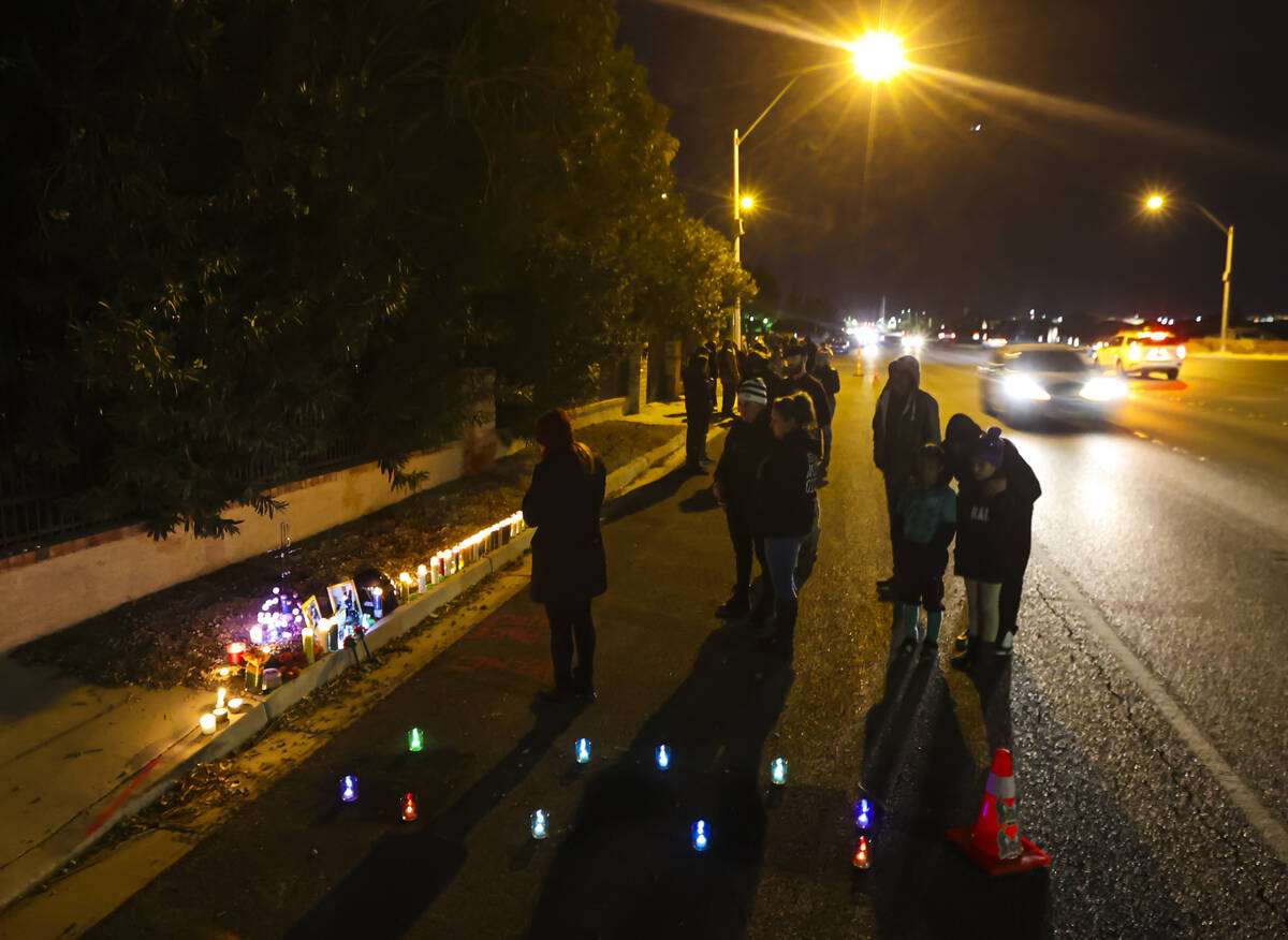 Family and friends place candles at the scene of a vigil where 28-year-old motorcyclist Rhianno ...