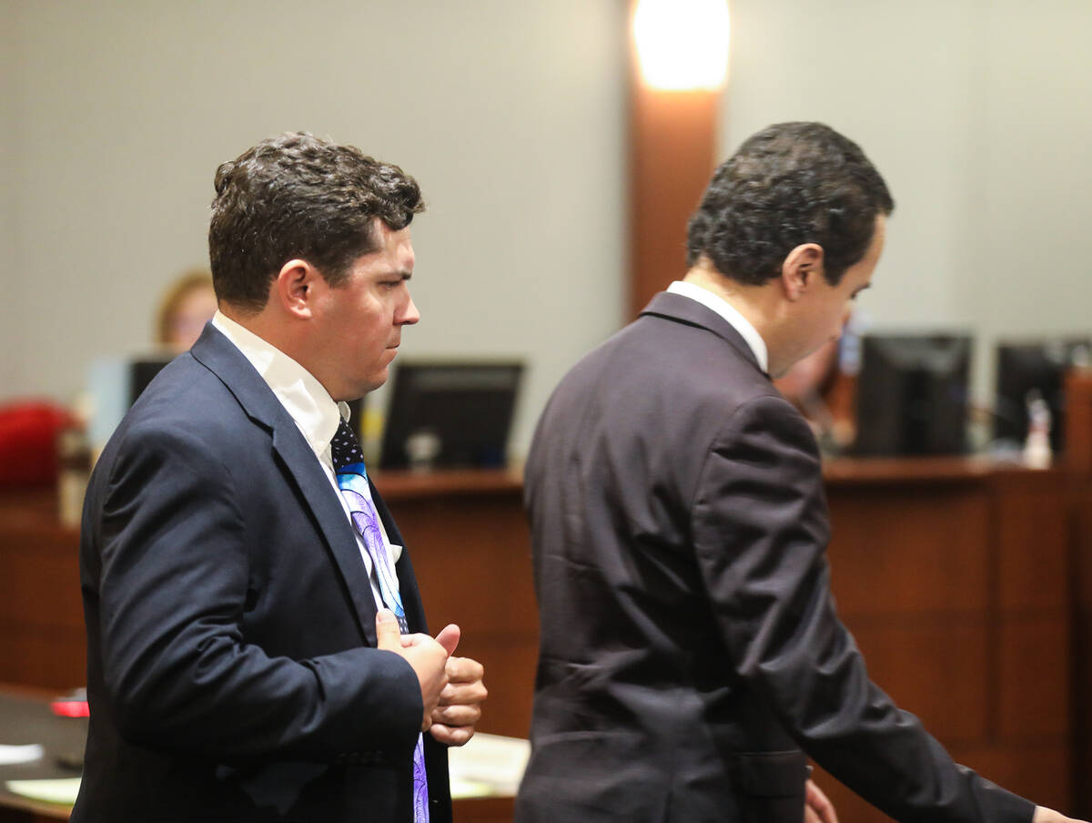 Joshua Buckingham, left, enters the courtroom for his sentencing at the Regional Justice Center ...