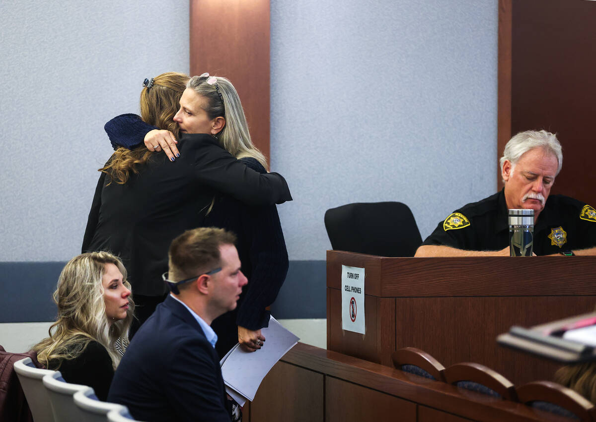 Stephanie Reiner, wife to Randy Reiner, is hugged by a family member after reading her victim i ...