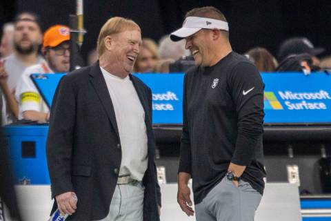 Raiders owner Mark Davis, left, and head coach Josh McDaniels share moment before an NFL game a ...