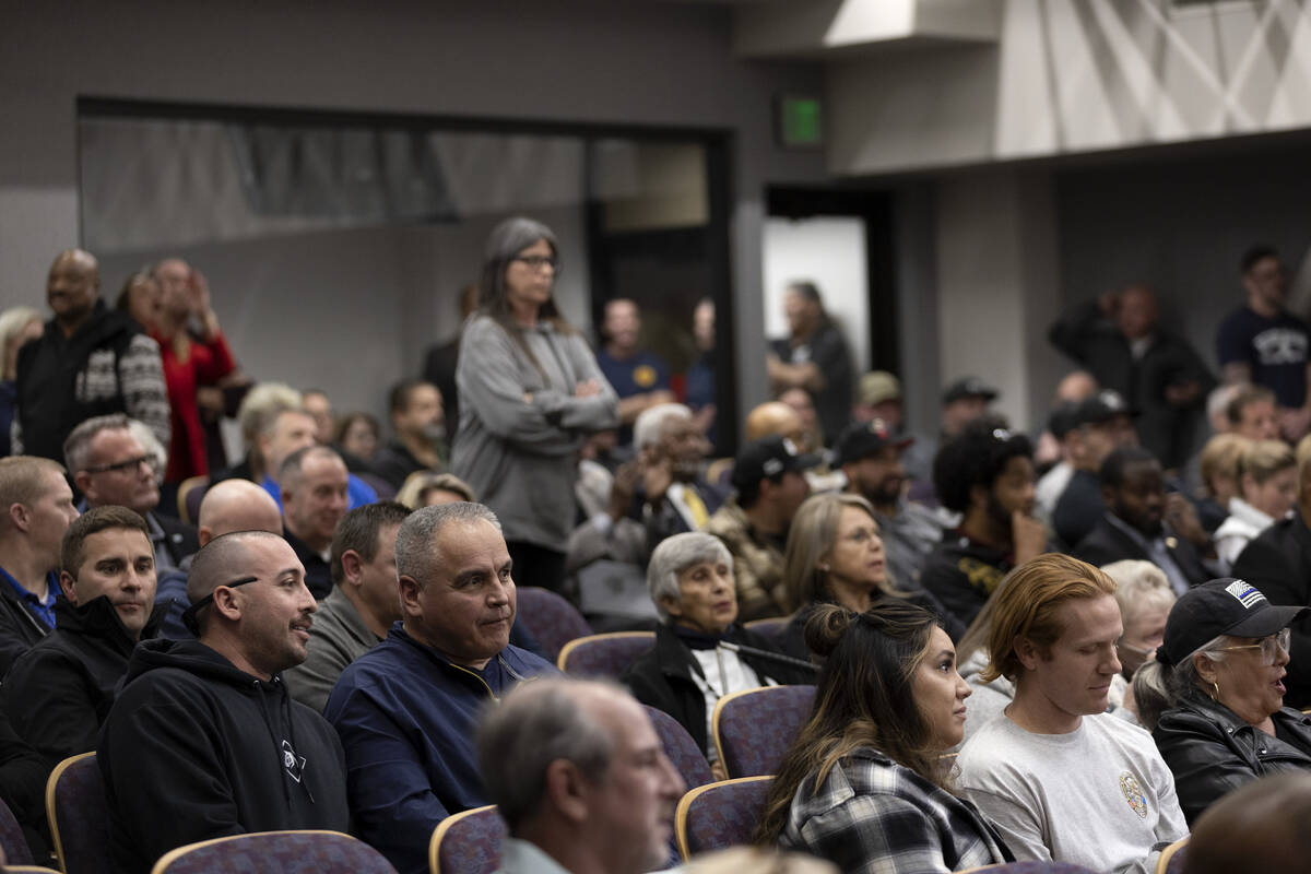 Attendees of a city council hearing react to comments from Henderson Mayor Debra March at Hende ...