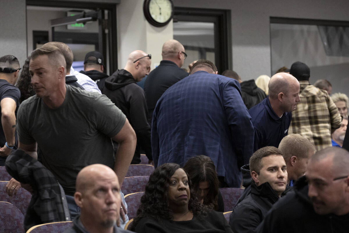 Attendees of a city council hearing get up and leave following comments from Henderson Mayor De ...