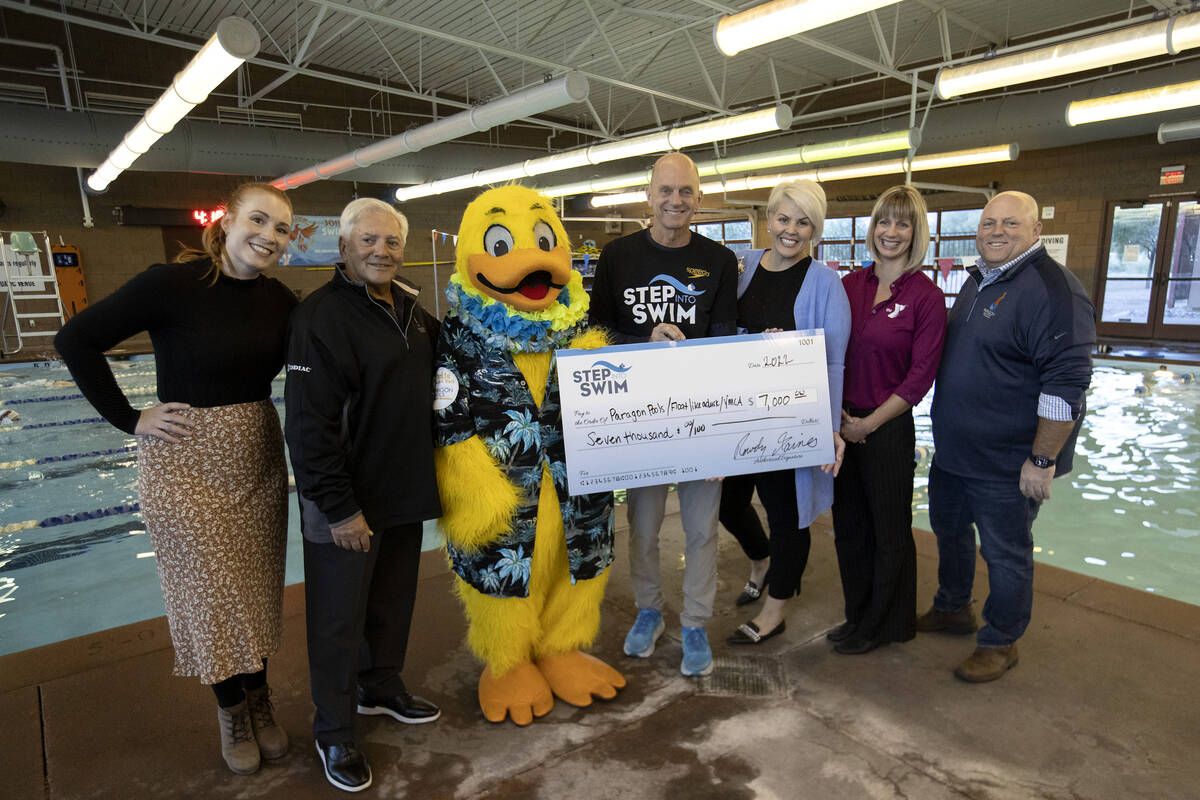 Olympic Gold Medalist Rowdy Gaines, center, poses with the beneficiaries of Step Into Swim's do ...