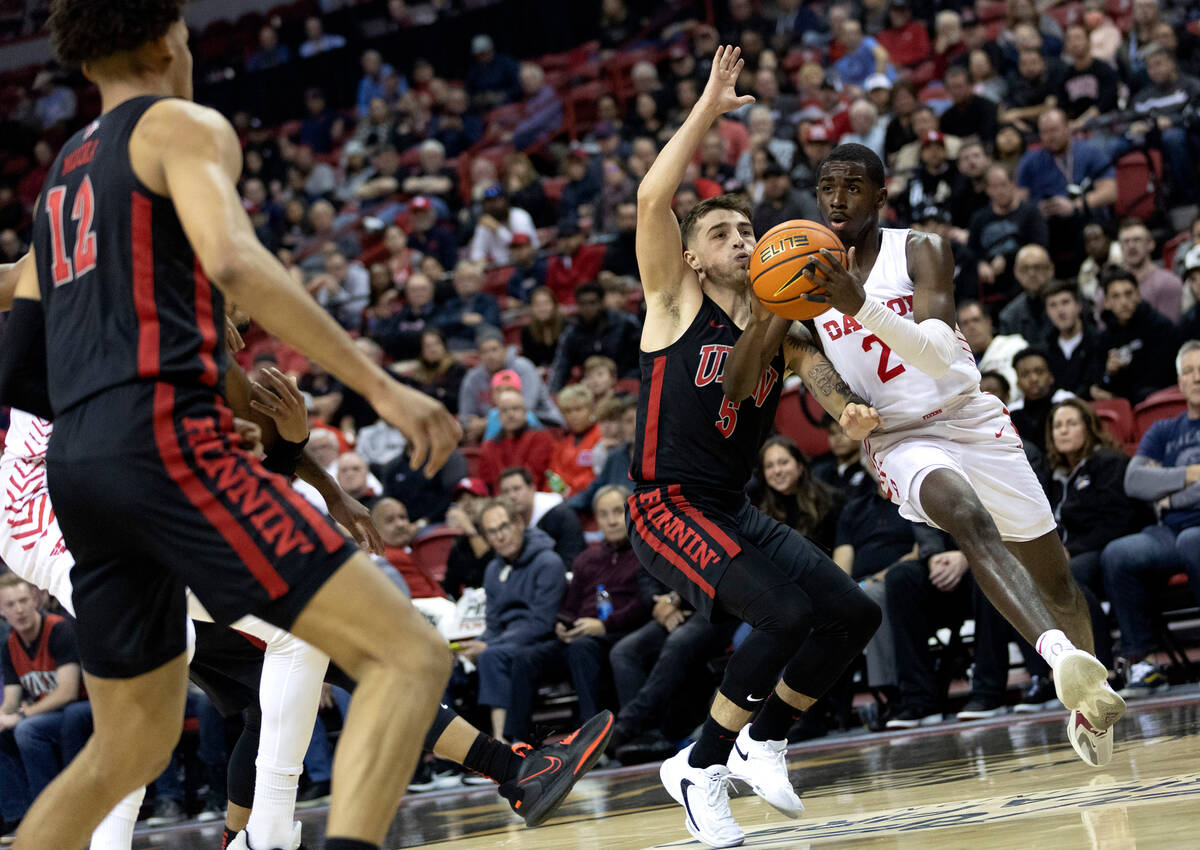 Dayton Flyers forward Toumani Camara (2) drives around UNLV Rebels guard Jordan McCabe (5) duri ...