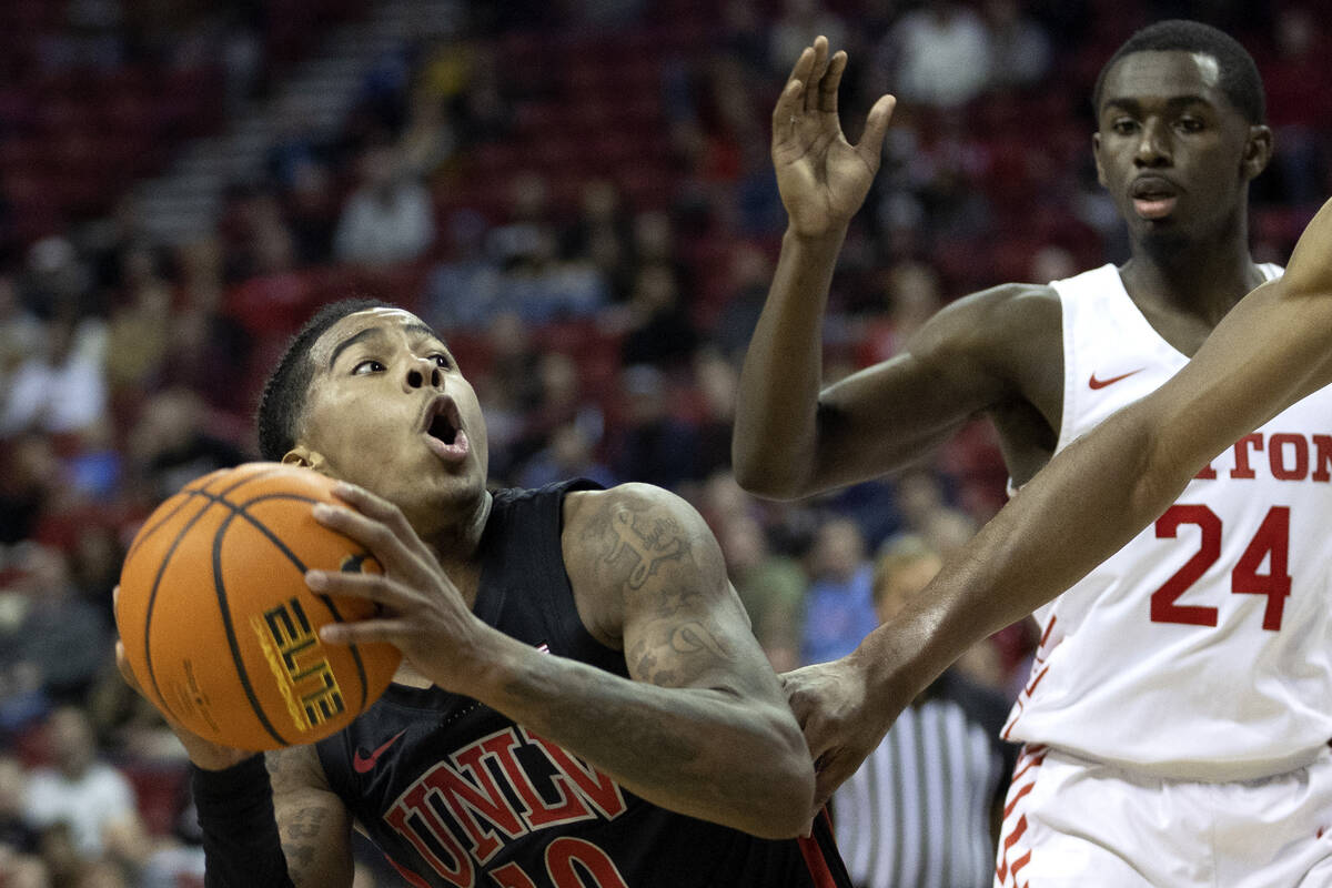 UNLV Rebels guard Keshon Gilbert (10) looks to shoot while the Dayton Flyers put pressure on hi ...