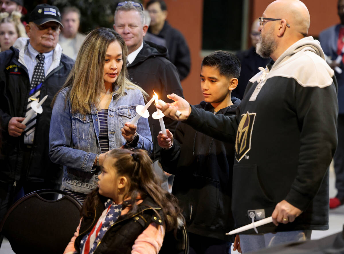 Poet and retired Metropolitan Police Department Capt. Harry Fagel lights candles with Stephanie ...
