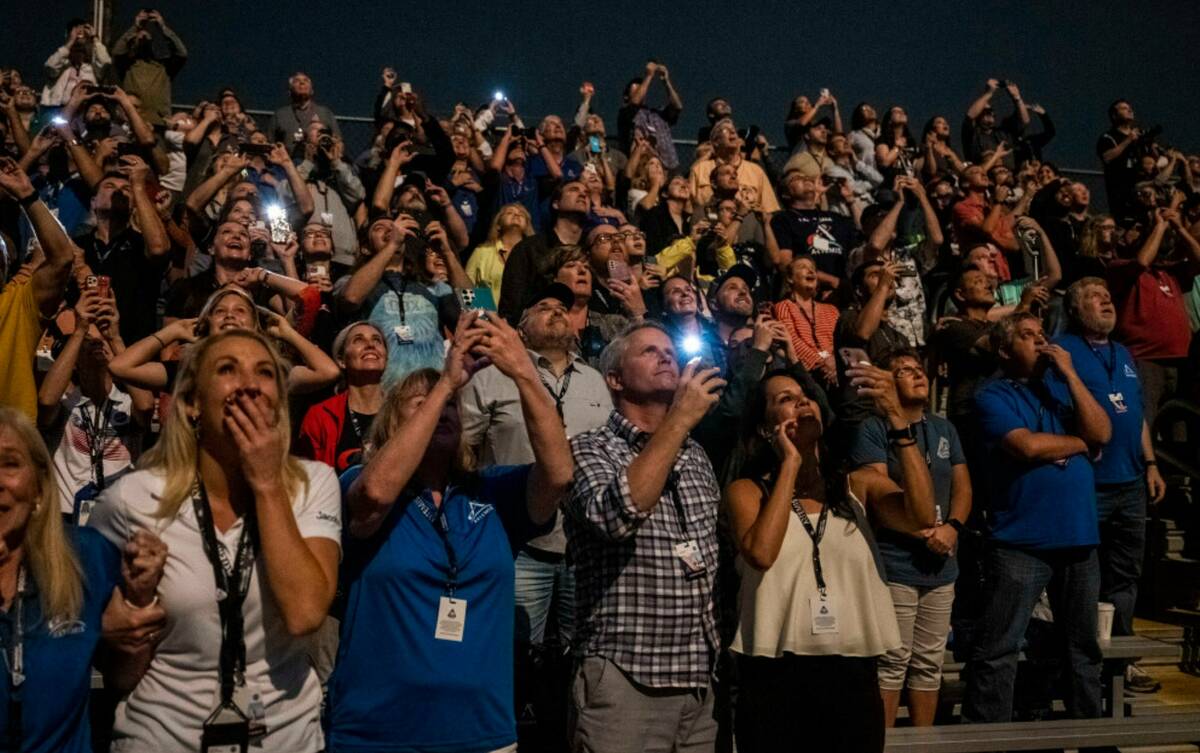 Guests at the Banana Creek watch the launch of NASA's Space Launch System rocket carrying the O ...