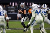 Raiders quarterback Derek Carr (4) looks to throw past Indianapolis Colts defenders during the ...