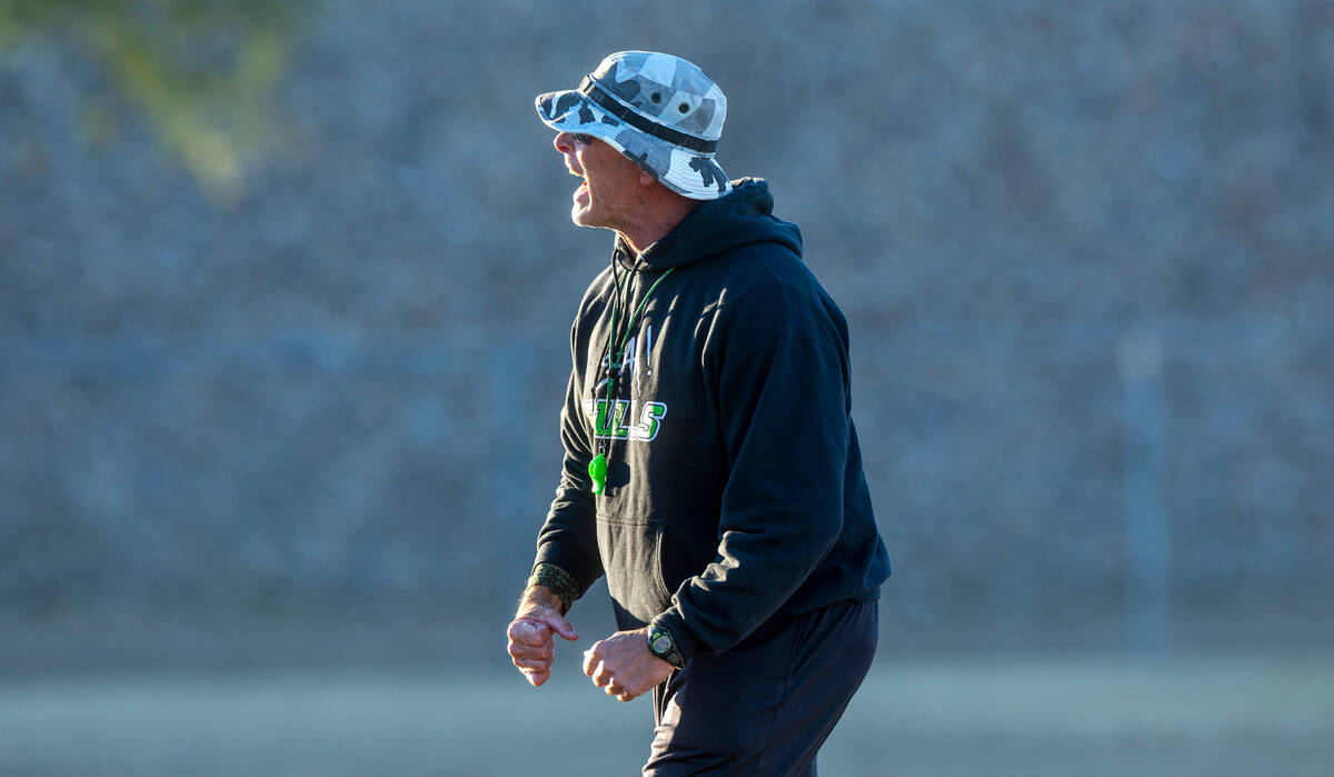 SLAM Academy Head Coach Mike Cofer motivates his players during football practice while prepari ...