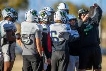SLAM Academy Head Coach Mike Cofer reviews a formation during football practice while preparing ...