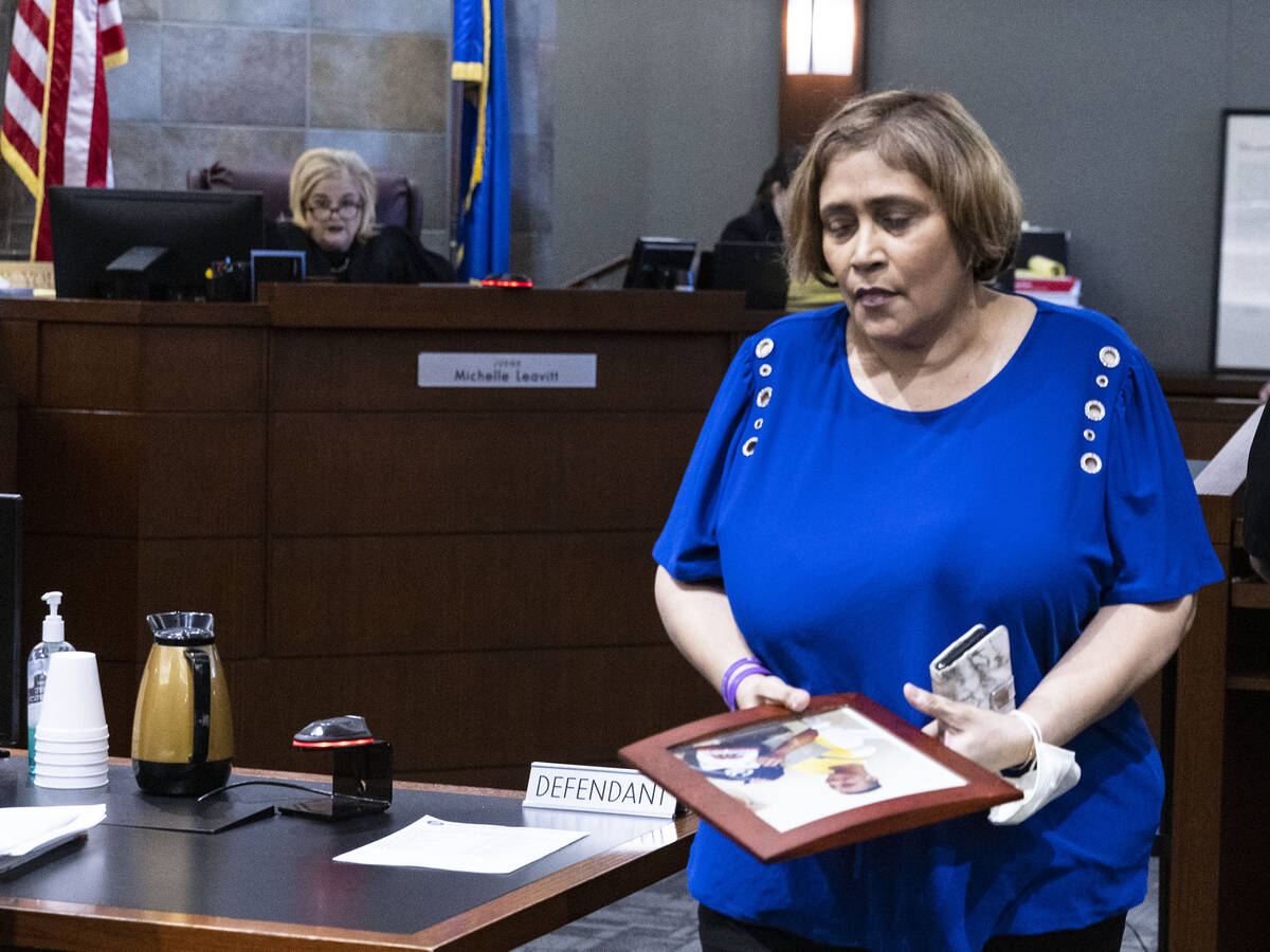 Veronica Melton, the mother of shooting victim Giovanni, holding her son's photograph leaves th ...