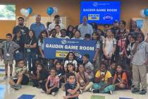 Former Vegas Golden Knight defenseman Ryan Reaves (third adult from left), Gaudin Ford executiv ...