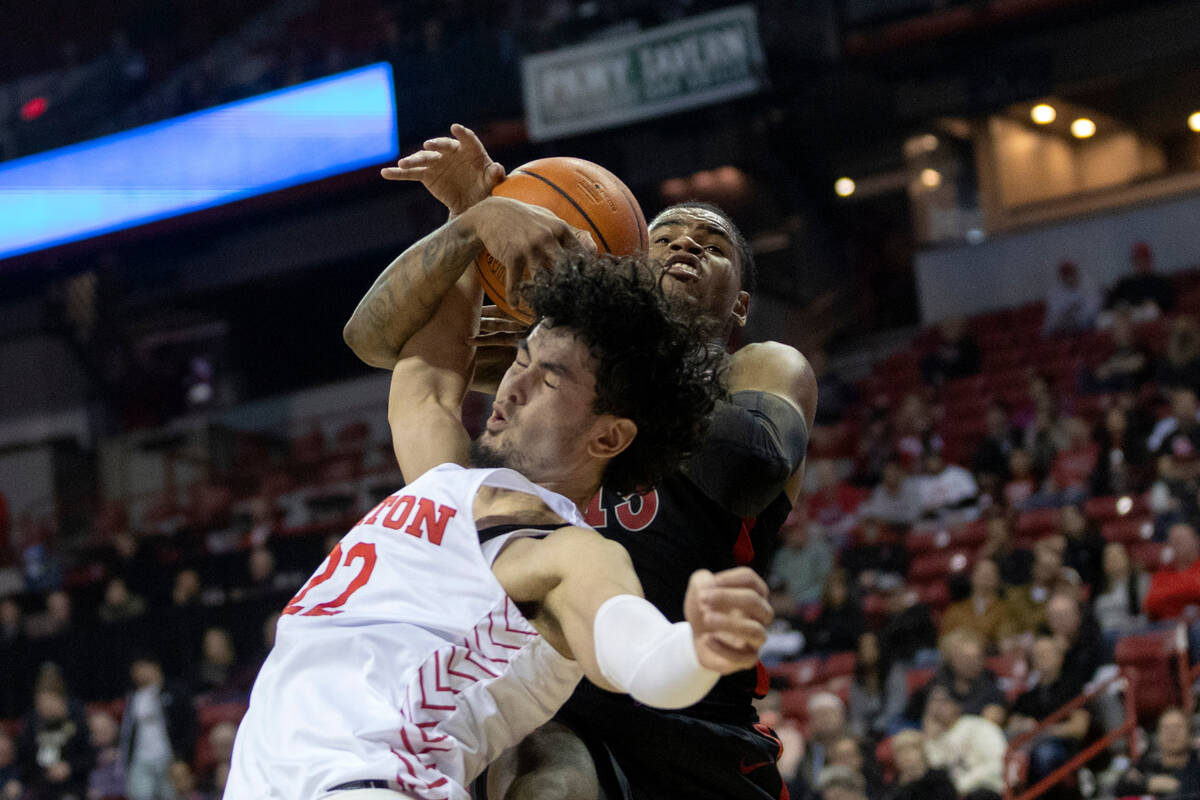 UNLV Rebels guard Luis Rodriguez (15) blocks a shot by Dayton Flyers forward Mustapha Amzil (22 ...