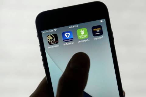 FanDuel, DraftKings and other online gambling apps are displayed on a phone in San Francisco, M ...