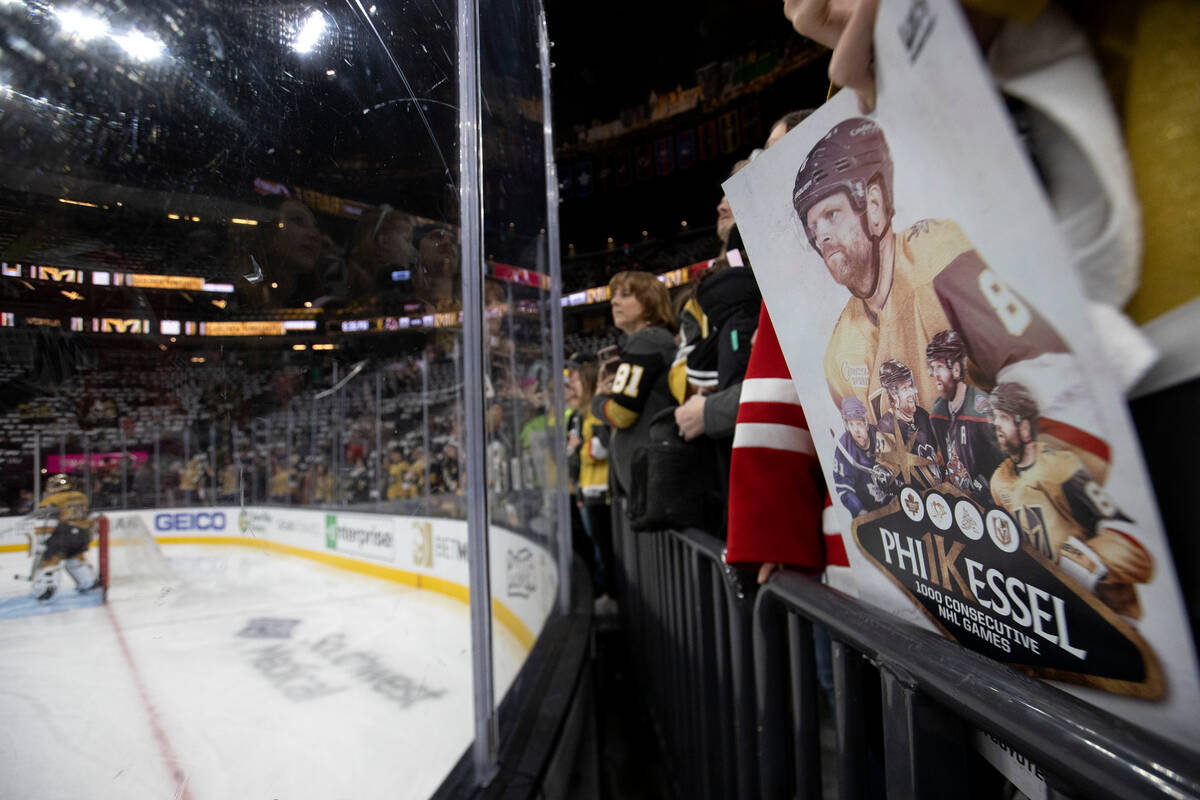 A Golden Knights fan holds a sign for center Phil Kessel (8), who is about to play his 1000th c ...