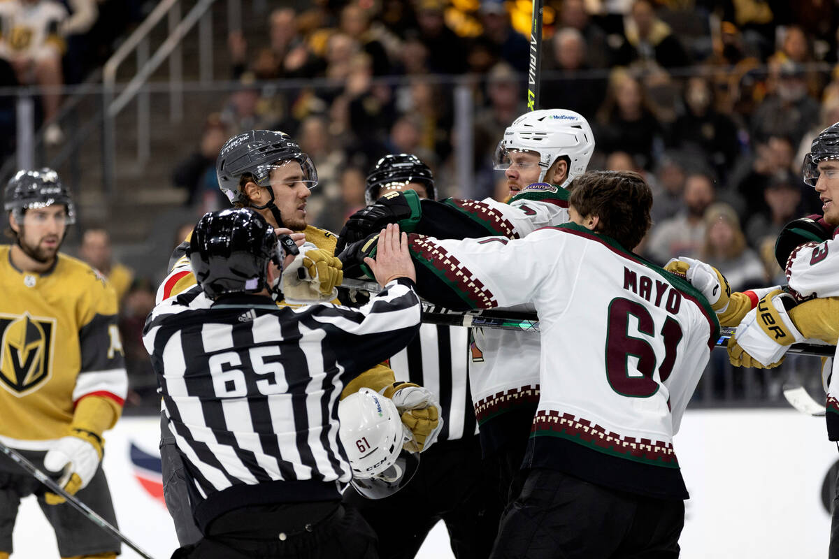 Golden Knights center Brett Howden, center left, and Coyotes left wing Lawson Crouse, center ri ...