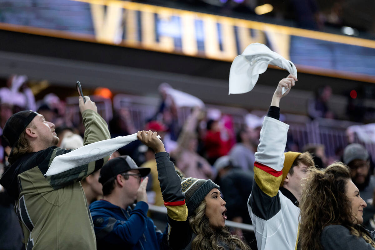 Golden Knights fans cheer for their team after they won an NHL hockey game against the Coyotes ...
