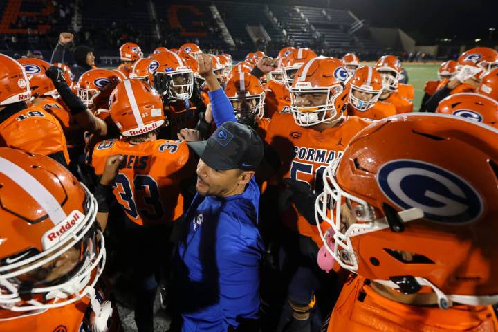 Bishop Gorman head coach Brent Browner huddles with players after defeating Desert Pines in a C ...