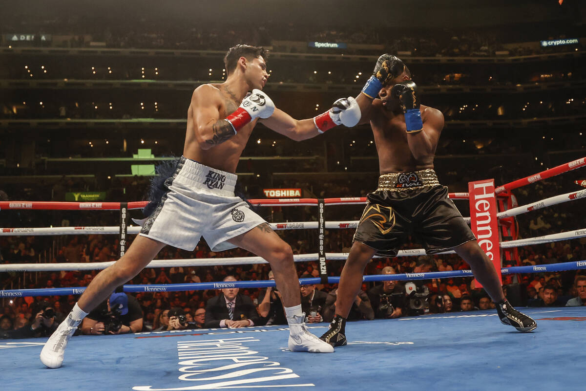 Ryan Garcia, left, and Javier Fortuna exchange punches during a lightweight boxing match Saturd ...