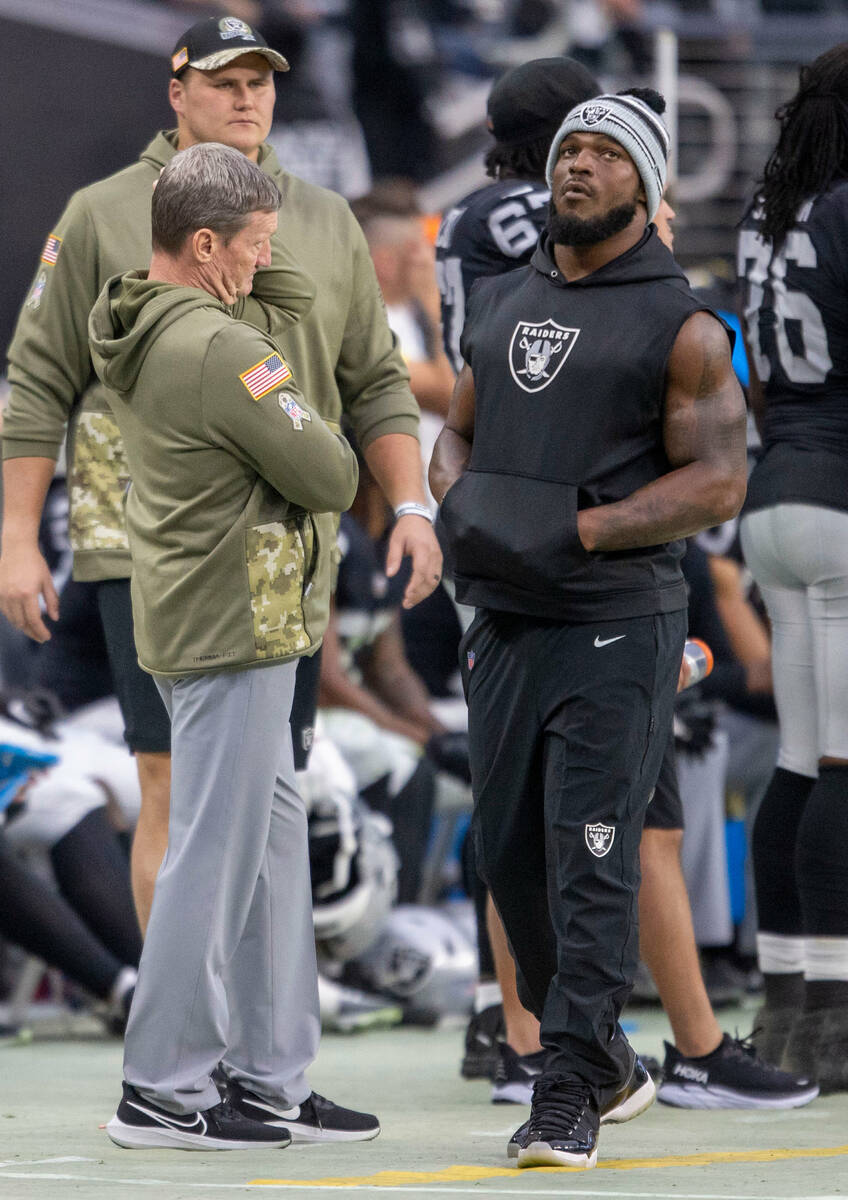Raiders linebacker Denzel Perryman, right, walks on the sideline during the first half of an NF ...