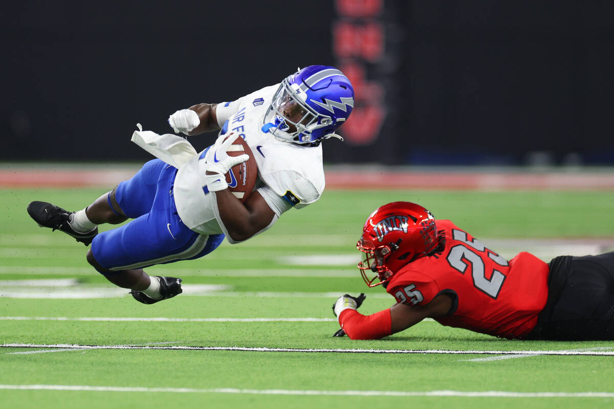 UNLV Rebels defensive back Jordyn Morgan (25) tackles Air Force Falcons running back John Lee E ...