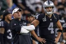 Raiders head coach Josh McDaniels and quarterback Derek Carr (4) look on from the sidelines as ...