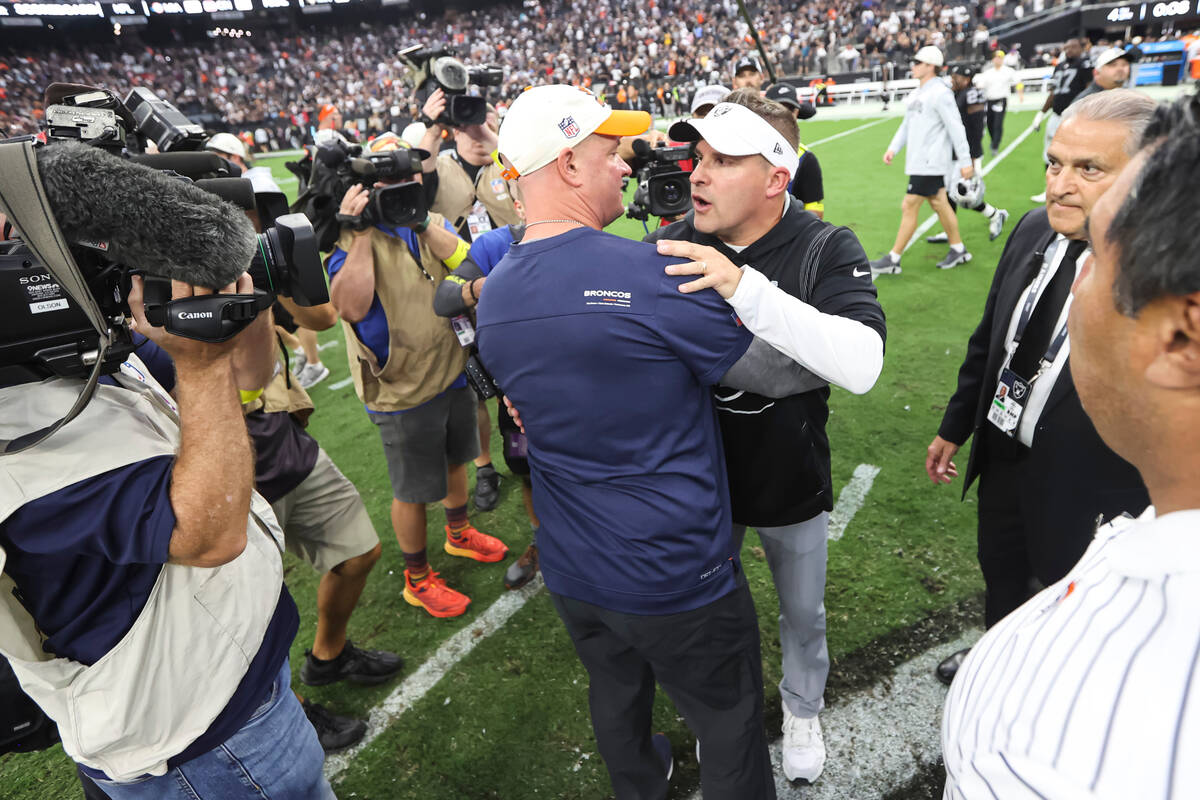 Raiders head coach Josh McDaniels greets Denver Broncos head coach Nathaniel Hackett after McDa ...
