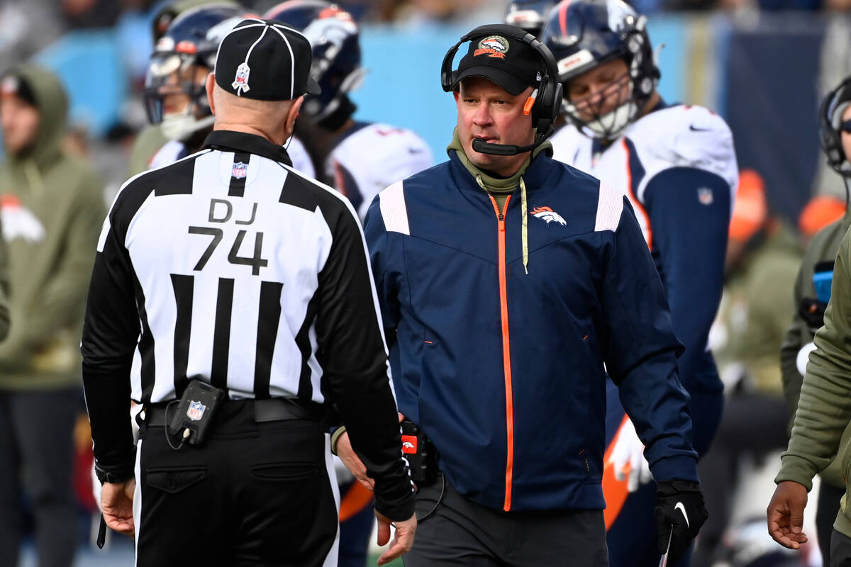 Denver Broncos head coach Nathaniel Hackett talks with an official during the first half of an ...