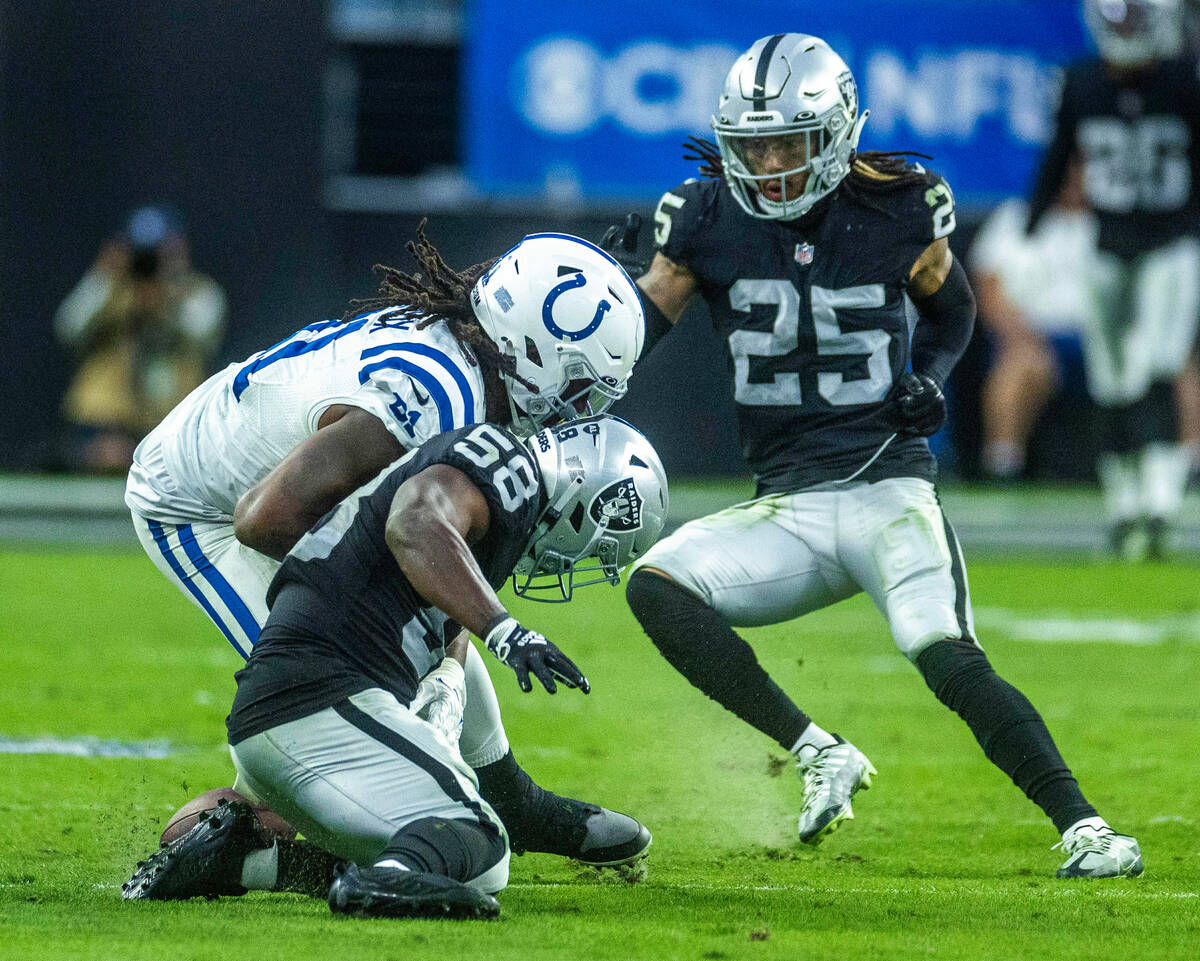 Raiders linebacker Darien Butler (58) attempts to recover a fumble as Indianapolis Colts tight ...