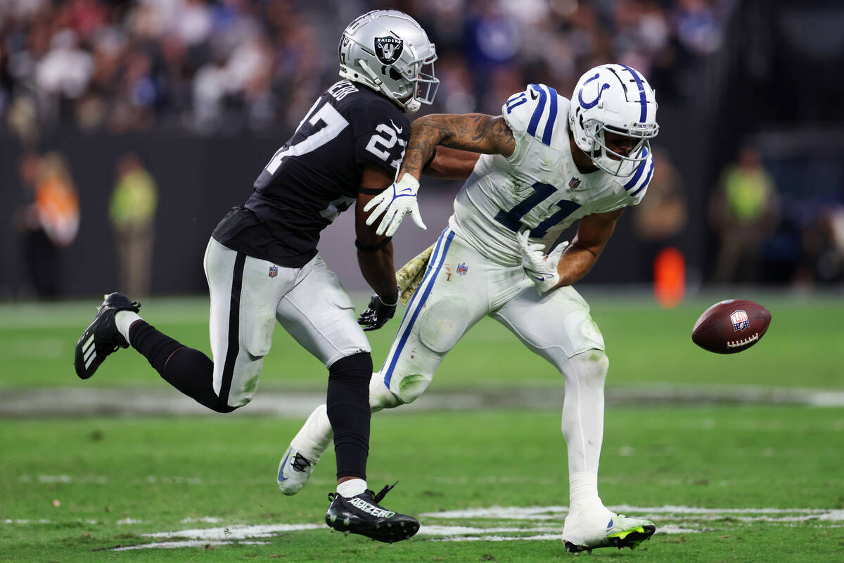 Raiders cornerback Sam Webb (27) forces a fumble by Indianapolis Colts wide receiver Michael Pi ...