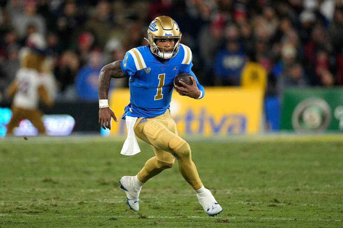 UCLA quarterback Dorian Thompson-Robinson runs the ball during the first half of an NCAA colleg ...