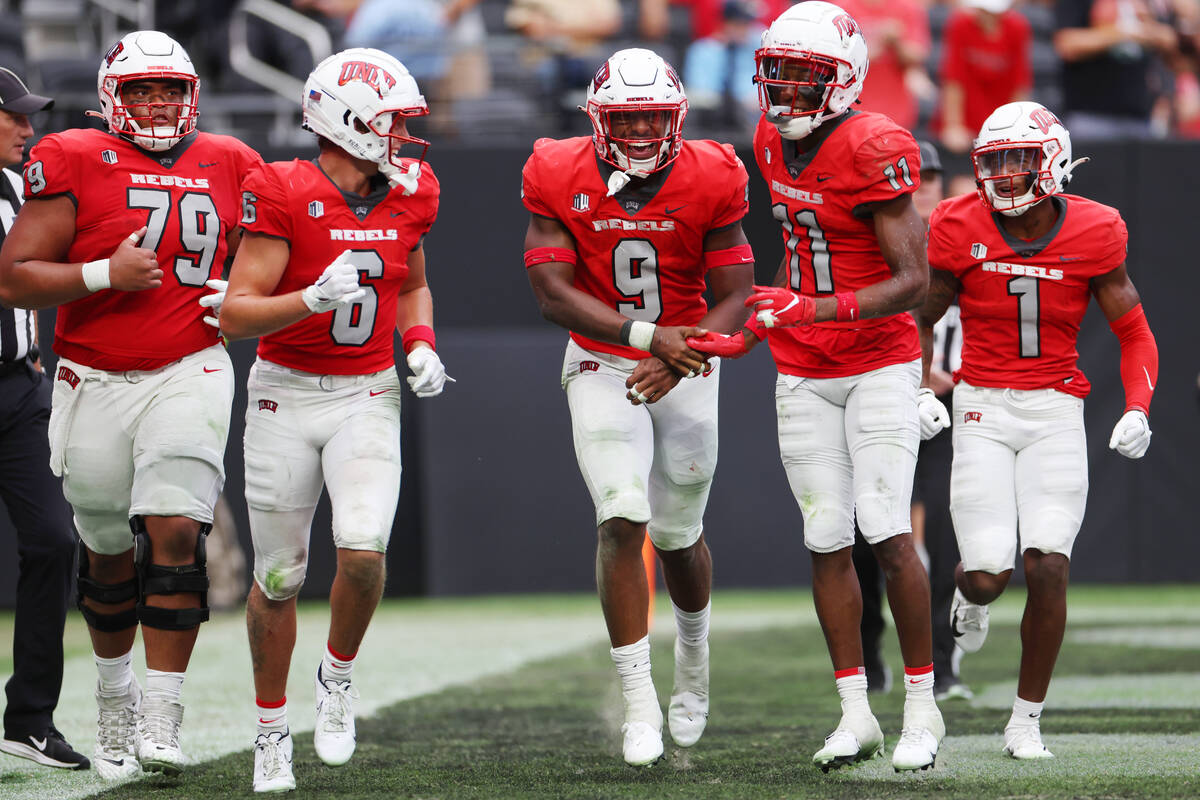 UNLV Rebels running back Aidan Robbins (9) celebrates his touchdown with wide receiver Ricky Wh ...