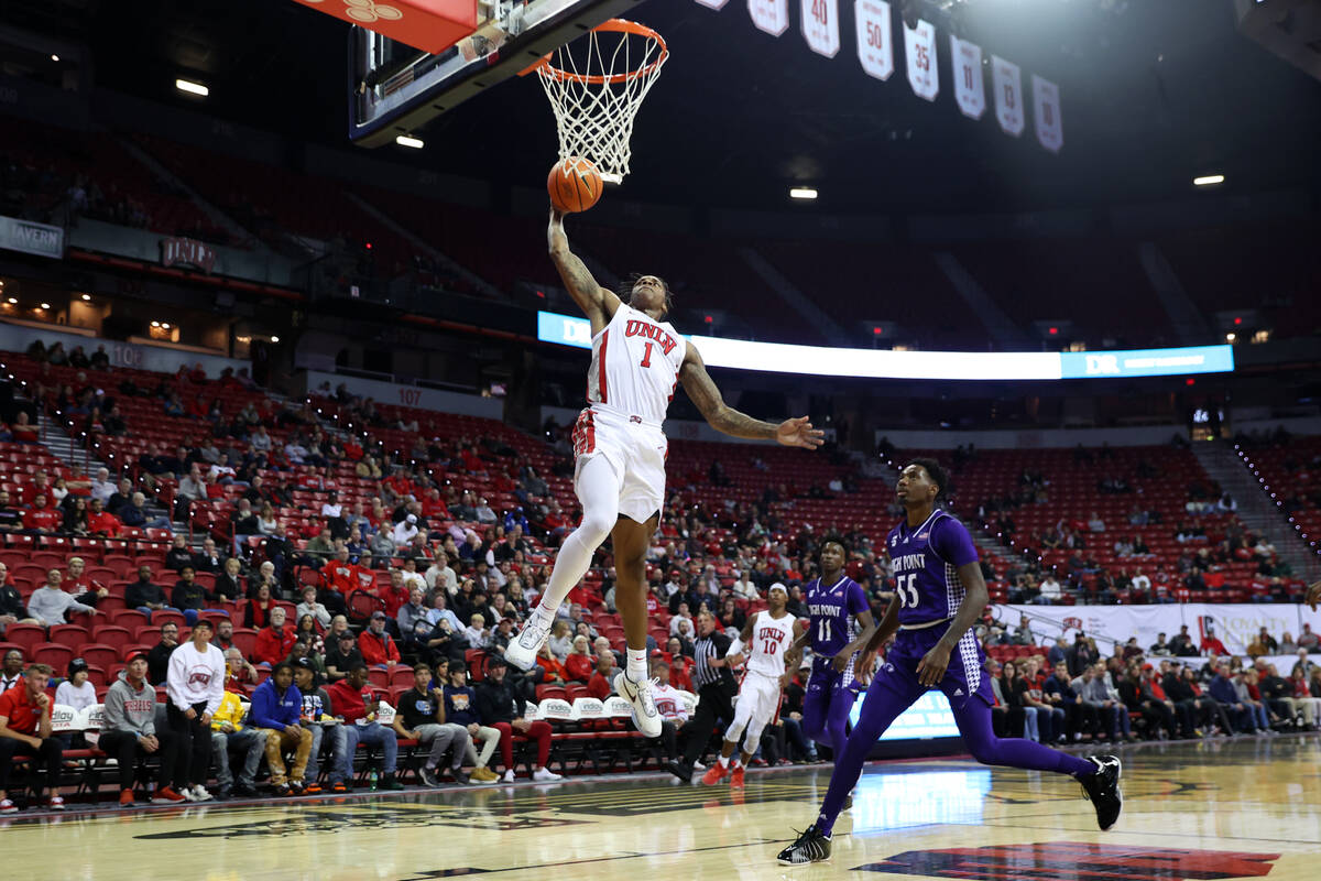 UNLV Rebels guard Elijah Parquet (1) goes up for a dunk as High Point Panthers forward Zack Aus ...