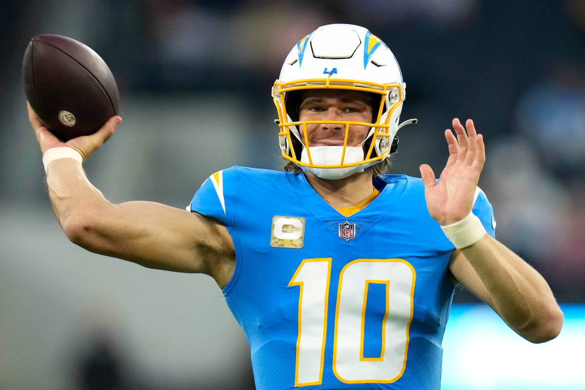 Los Angeles Chargers quarterback Justin Herbert warms up prior to an NFL football game against ...