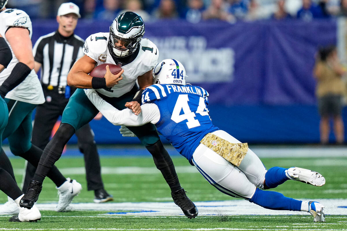 Philadelphia Eagles quarterback Jalen Hurts (1) is sacked by Indianapolis Colts linebacker Zair ...